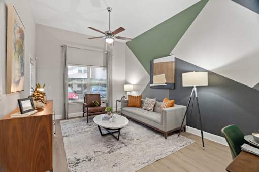 Modern living room with geometric accent wall at Urban Crest Apartments, San Antonio