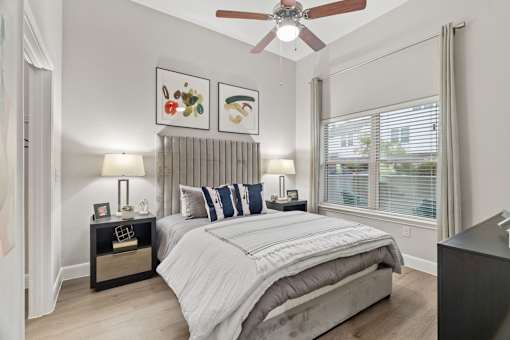 Modern bedroom with upholstered headboard and nightstands at Urban Crest Apartments, San Antonio, 78209