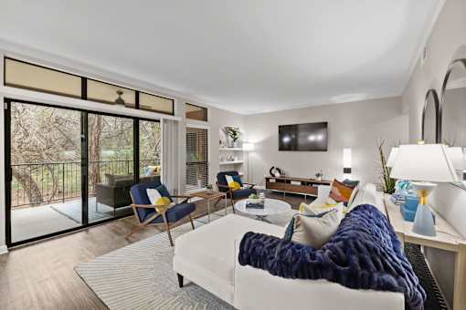 a living room with a white couch and a tv