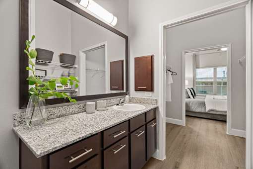 Master bathroom vanity with granite countertop at Urban Crest Apartments, Texas