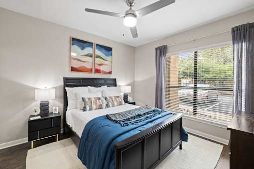 a bedroom with a bed and a ceiling fan