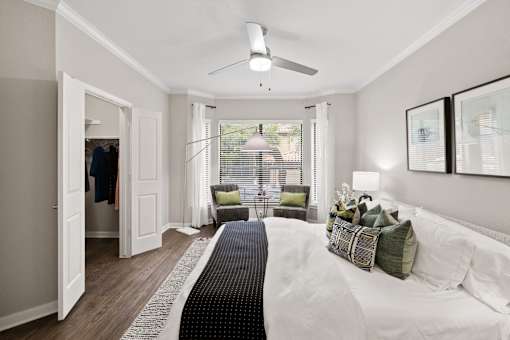 a bedroom with a large bed and a ceiling fan