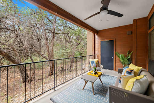a balcony with a couch and a table