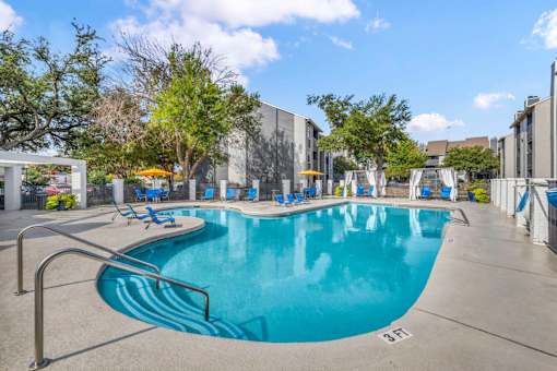 A large swimming pool with a metal ladder on the side.