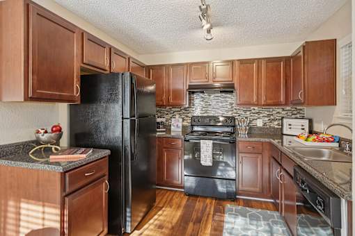 Kitchen with wooden cabinets at Radbourne Lake Apartments, Charlotte, 28269