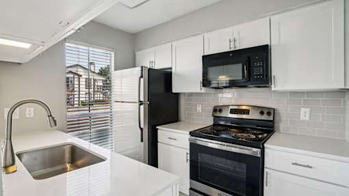 Kitchen with cabinets at Keller Oaks, Carrollton, TX