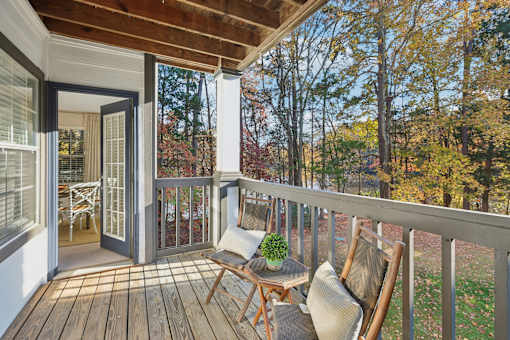 Wooden deck with chair at Radbourne Lake Apartments, Charlotte, NC