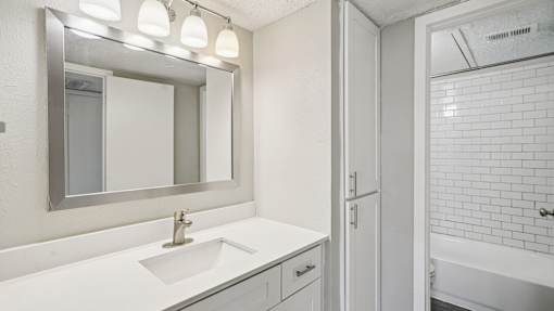 White Bathroom with mirror at Keller Oaks, Carrollton, Texas