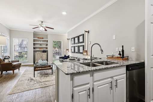 A kitchen with a marble countertop and a ceiling fan.