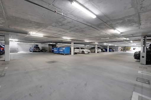 A parking garage with several cars parked inside.