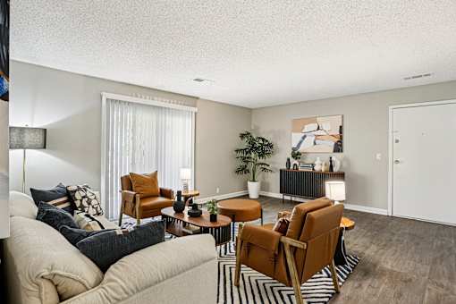 Living room with brown chairs at The Grove Brentwood, Nashville