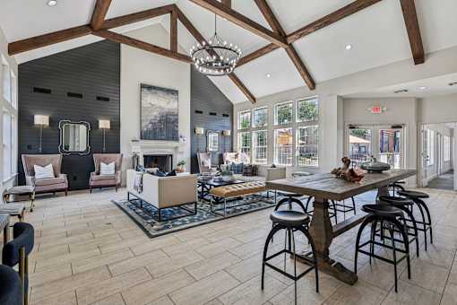 A large open living room with a fireplace and a dining table.