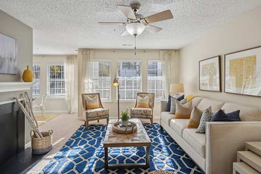 Living room with ceiling fan at Radbourne Lake Apartments, North Carolina, 28269