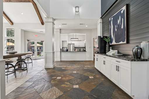 A kitchen with a black and white checkered floor.