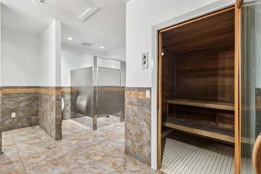 A bathroom with a walk-in shower and a wooden door.