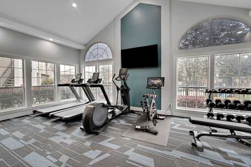 A spacious home gym with a variety of exercise equipment.