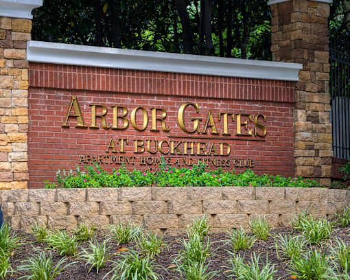 A brick wall with the words Arbor Gates at Buckhead written on it.