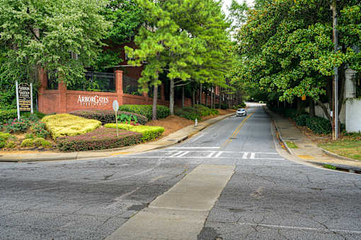 A street view of a residential area with a sign that reads "Arborcates.".