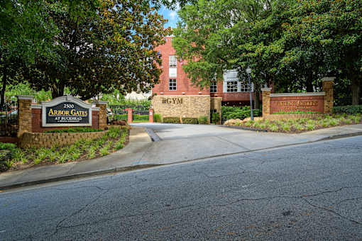 The entrance to Arbor Gates at Richfield is surrounded by trees.