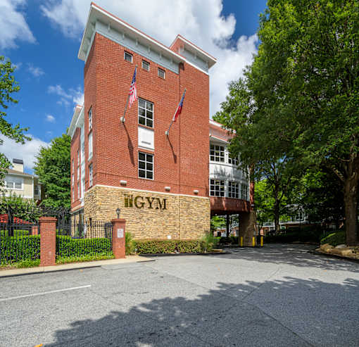 A red brick building with the word "GYM" on it.