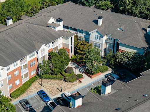 A large building with a parking lot in front.