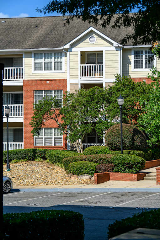 A building with a red brick wall and a white balcony.