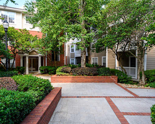 A brick pathway leads to a building entrance.