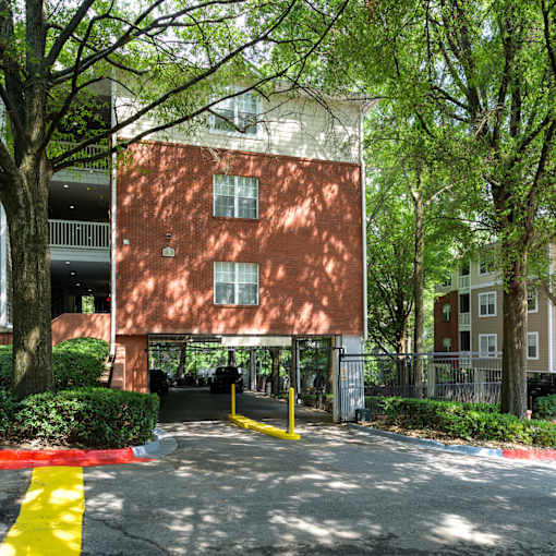 A red brick building with a yellow line on the ground in front of it.