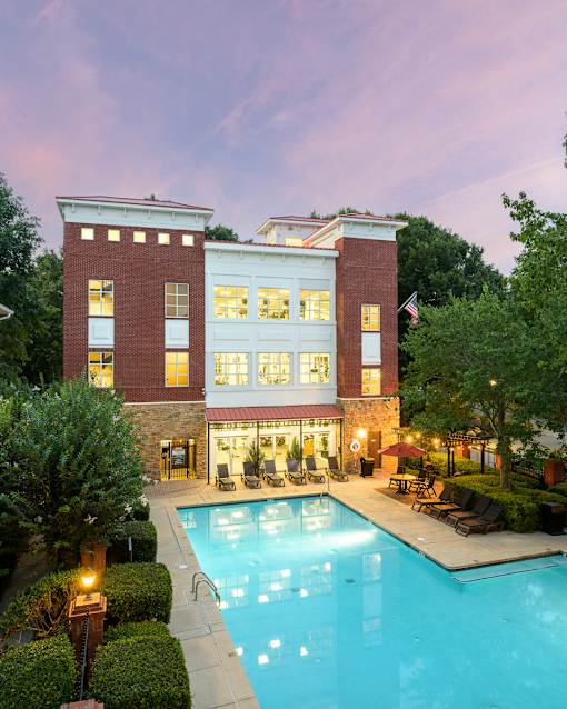 A large house with a pool in front.