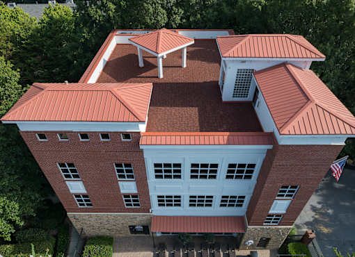 A red and white building with a flag on the right side.