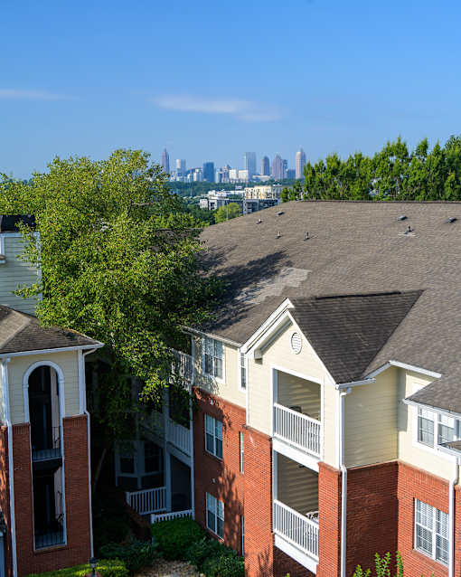 Apartment buildings with a city skyline in the background.