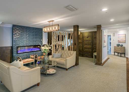 A living room with a fireplace and a chandelier.
