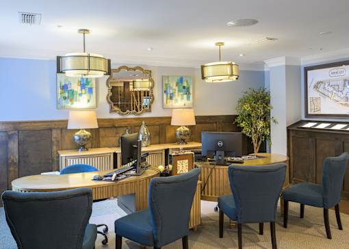 A conference room with a long table and chairs.