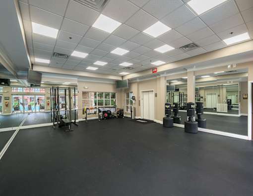 A gym with a black floor and white walls.
