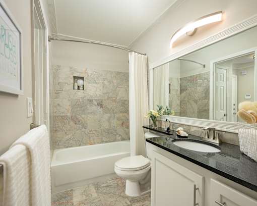 A bathroom with a toilet, sink, and a bathtub.