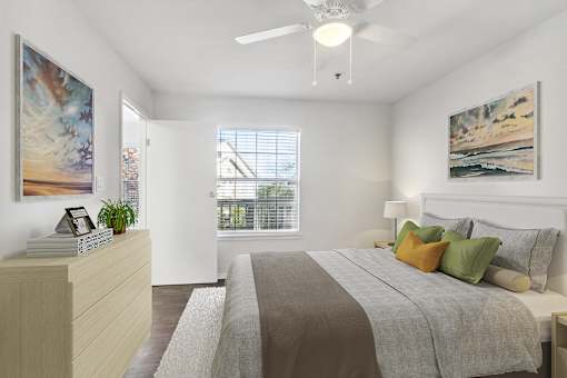 A bedroom with a large bed and a painting on the wall.