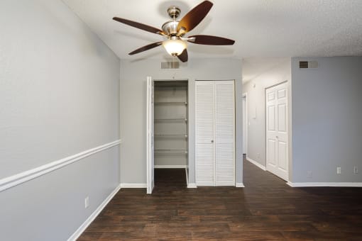 an empty living room with a ceiling fan and a closet at The Grove Brentwood, Tennessee, 37211