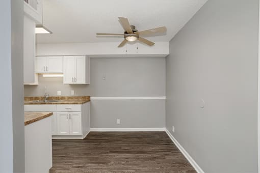 an empty kitchen with white cabinets and a ceiling fan at The Grove Brentwood, Nashville, TN ?