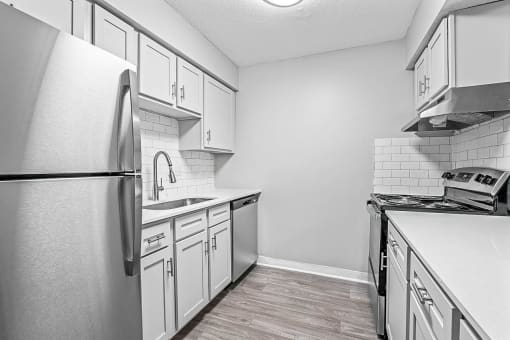 a kitchen with white cabinets and stainless steel appliances