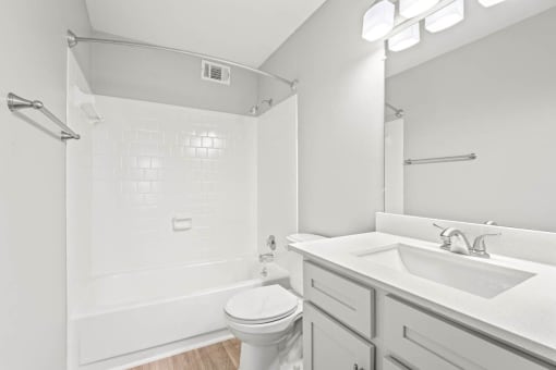 a bathroom with a sink toilet and bathtub