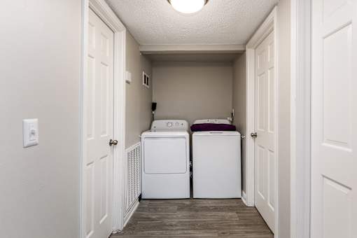 A small laundry room with a washer and dryer.