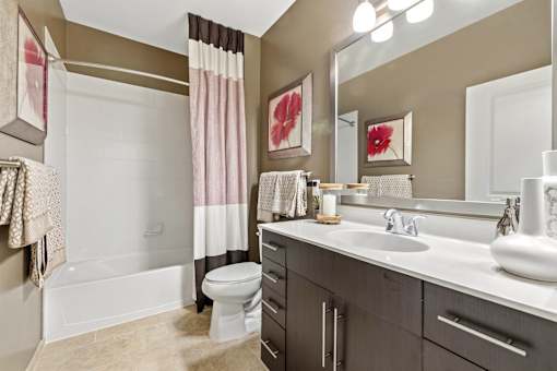 A bathroom with a white toilet, a white sink, and a white bathtub.