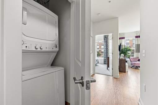 A white washing machine and dryer in a laundry room.