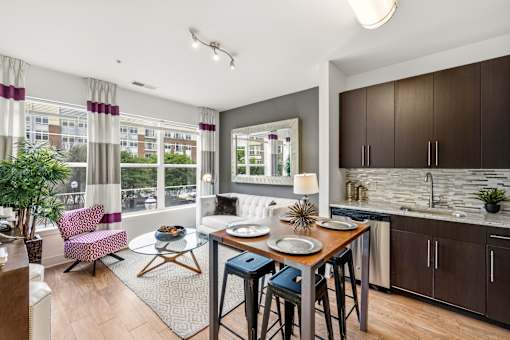 A modern kitchen with a dining table and chairs.