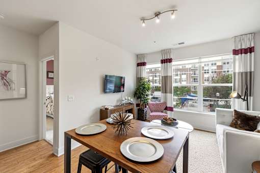 A dining room with a wooden table and chairs.