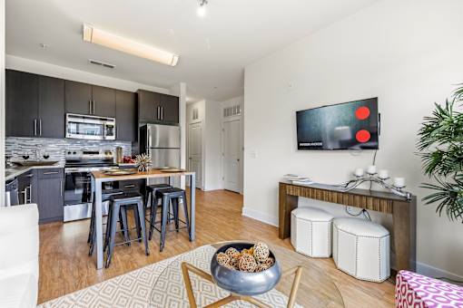 A modern kitchen with a dining table and chairs.