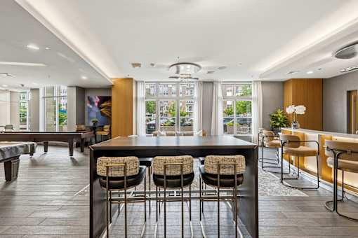 A modern kitchen with a bar area and seating.