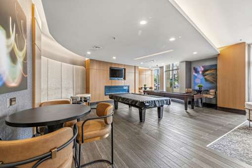 A modern dining room with a round table and chairs.