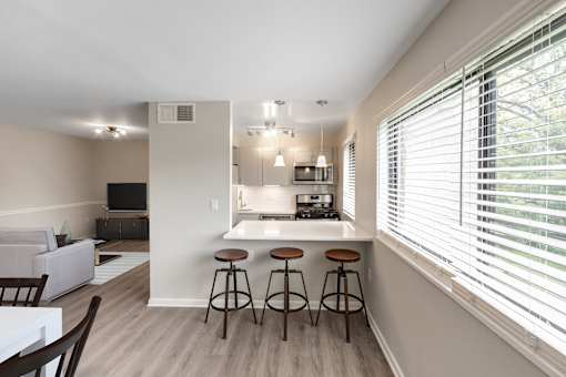 A kitchen with a bar stool and a countertop.