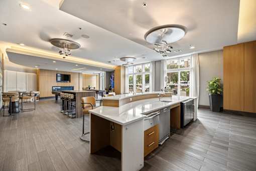 A modern kitchen with a large island and a dining area.